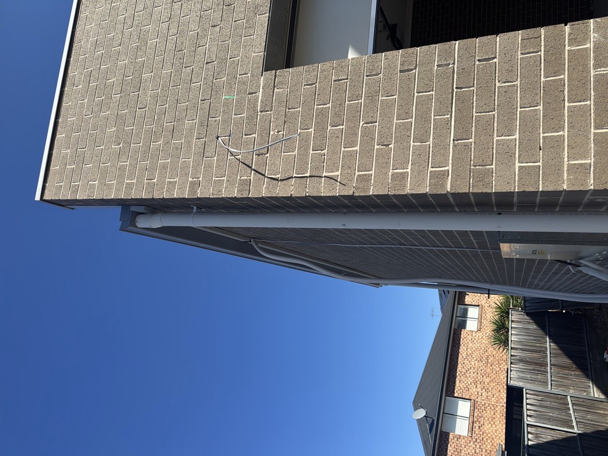 Downpipe not secured, recorded during a fixing stage inspection in Box Hill