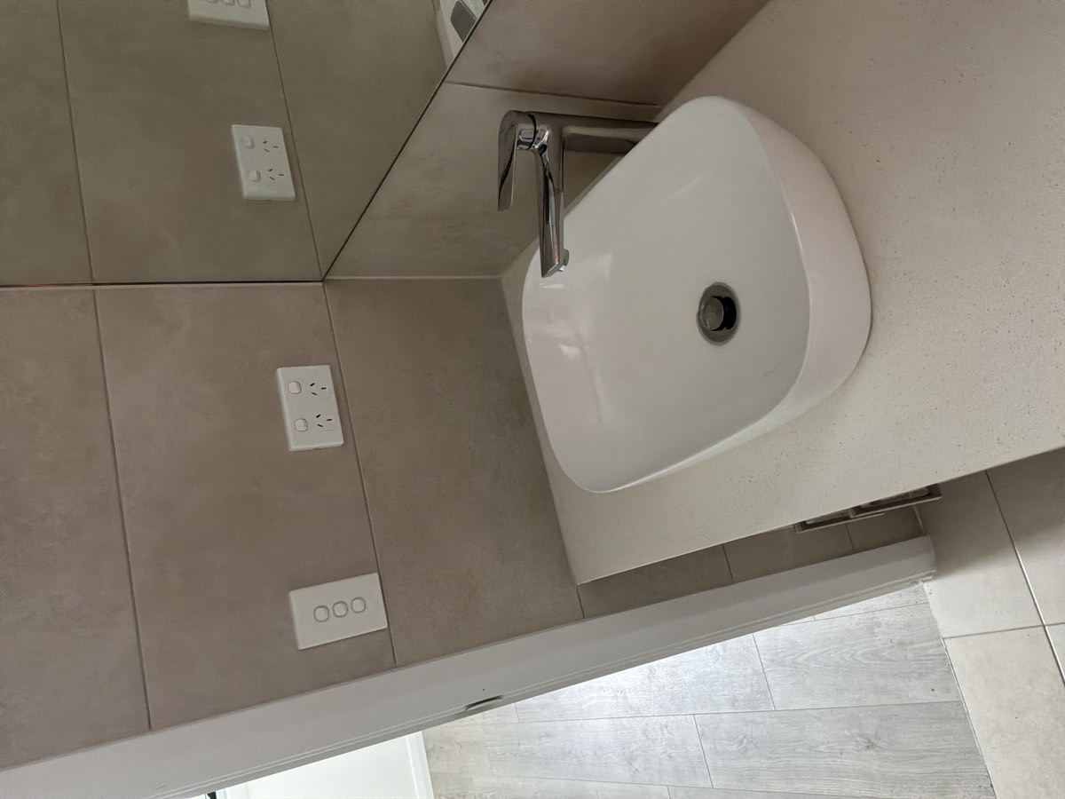 Light or switch too close to a shower and bath, recorded during a handover inspection in Box Hill